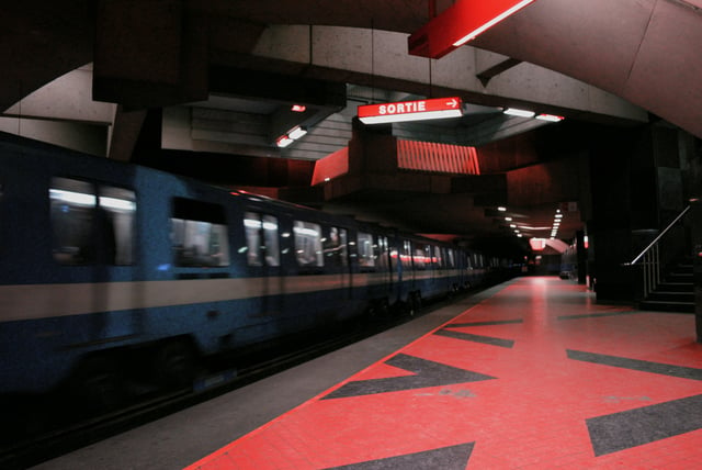 A train departs from Acadie station. The Montreal Metro has 68 stations over four lines.