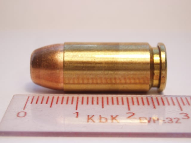 .40 S&W Jacketed Flat Point cartridge from the side.