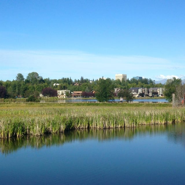 View from the Tony Knowles Coastal Trail near the mouth of Chester Creek. From foreground to background: Westchester Lagoon, the southern reaches of the Bootleggers Cove neighborhood, and the downtown skyline.