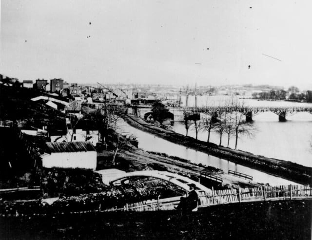 Georgetown around 1862. Overview of the C&O Canal, Aqueduct Bridge at right, and unfinished Capitol dome in the distant background.