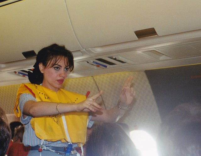 An EgyptAir flight attendant performing a pre-flight safety demonstration
