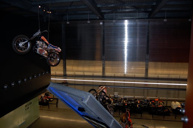 An Evel Knievel XR-750 suspended in air as if jumping, at the Harley-Davidson Museum
