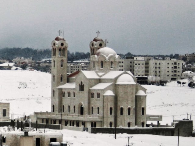 An eastern Orthodox church during a snowstorm in Amman.