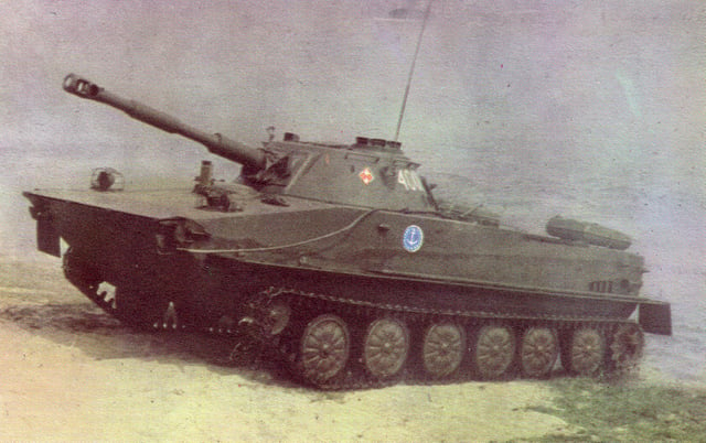 A Polish PT-76 amphibious light tank coming out of the water during an amphibious exercise. Note the two flat additional external fuel tanks at the rear corners of the hull.