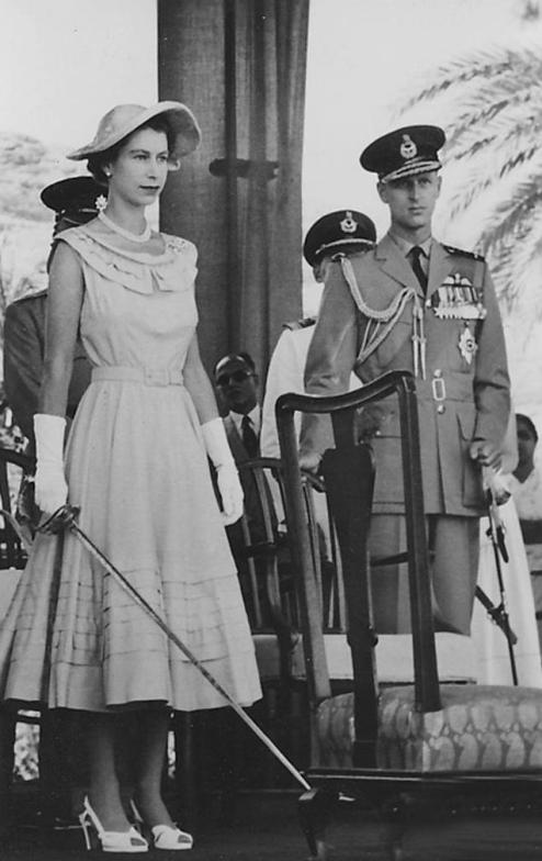 Queen Elizabeth II holding a sword, prepared to knight subjects in Aden in 1954
