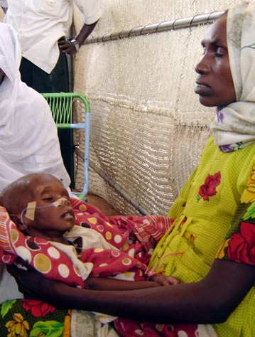 A mother with her sick baby at Abu Shouk IDP camp in North Darfur
