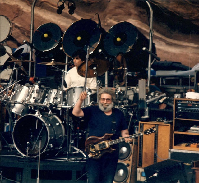 Grateful Dead performing at Red Rocks Amphitheatre in 1987: Jerry Garcia (custom Tiger guitar), Mickey Hart (drums).