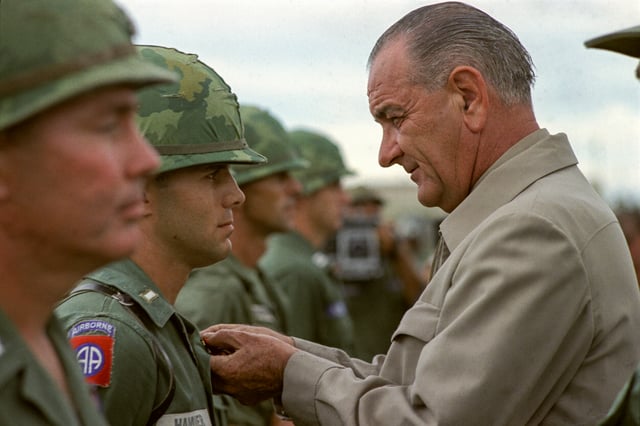 Awarding a medal to a U.S. soldier during a visit to Vietnam in 1966