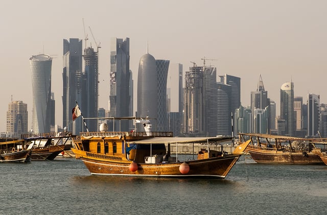 Traditional dhows in front of the West Bay skyline as seen from the Doha Corniche.