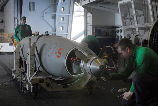 SNAD Jonathan Biles of VFA-22 helps reassemble an air refueling pod in the hangar bay of USS Ronald Reagan (CVN-76)