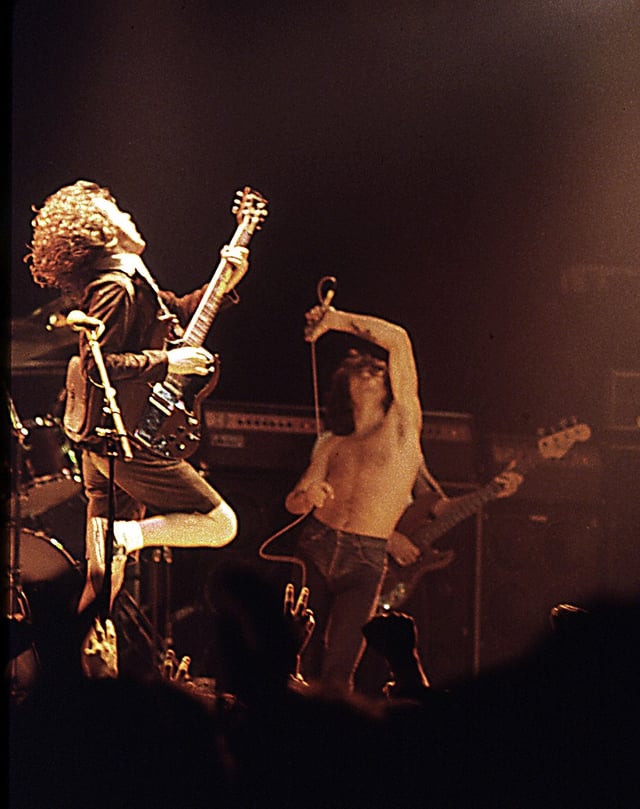AC/DC with Bon Scott (centre) pictured with guitarist Angus Young (left) and bassist Cliff Williams (back), performing at the Ulster Hall in August 1979