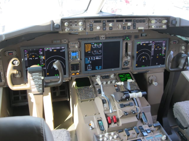 The upgraded glass cockpit of a 767-300F with 3 large 787-style LCDs.