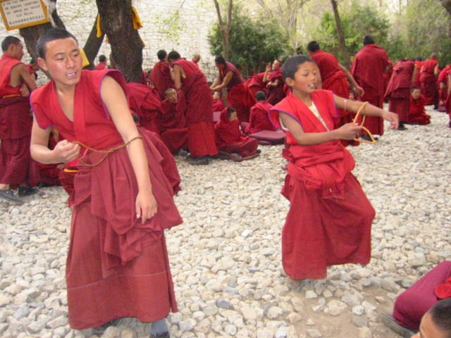 Buddhist monks practicing debate in Drepung Monastery
