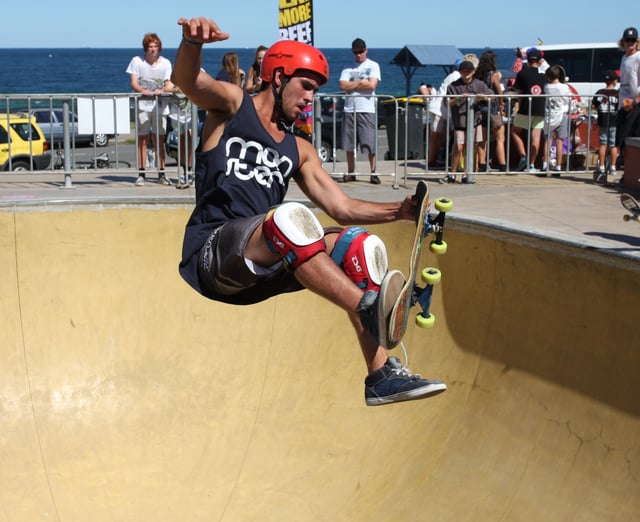 A skateboarder in mid flight performing a trick