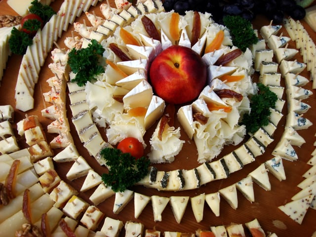 A platter with cheese and garnishes