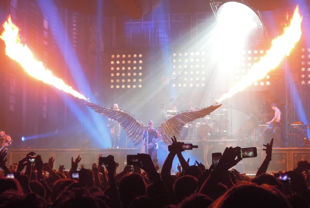 Lindemann at a Rammstein concert during a performance of "Engel", wearing angel wings fitted with flamethrowers