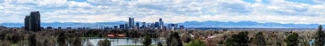 Panorama of Denver in early May, as seen from the Denver Museum of Nature and Science. Snow-capped Mount Evans can be seen to the left beyond the city skyline.