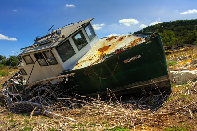 The 2011 Texas drought dried up many of central Texas' waterways. This boat was left to sit in the middle of what is normally a branch of Lake Travis, part of the Colorado River.