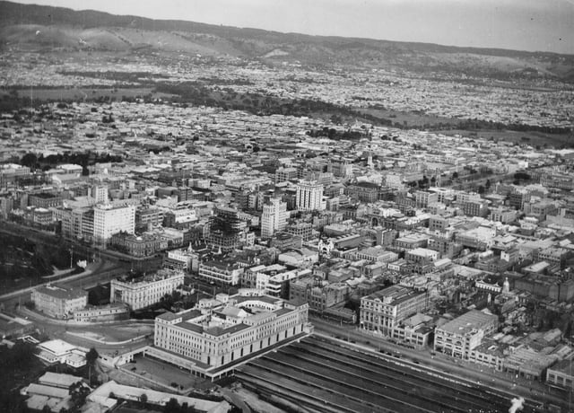 Aerial view of Adelaide in 1935, when it was Australia's third largest city. Note: Only the eastern half of Parliament House is completed.