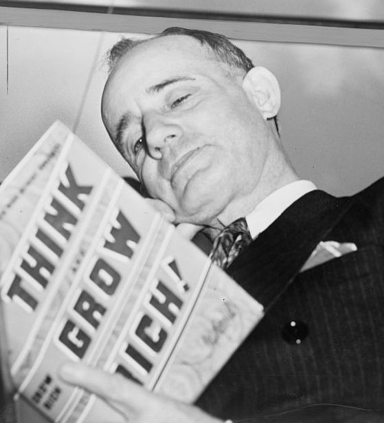 Napoleon Hill holding his book Think and Grow Rich, 1937.
