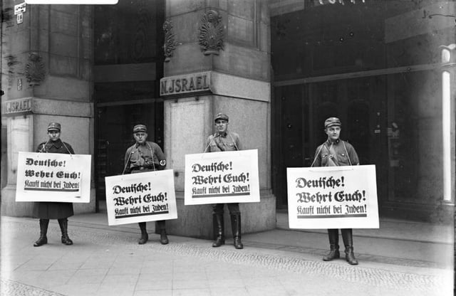 Nazi boycott of Jewish businesses: SA troopers urge a boycott outside Israel's Department Store, Berlin, 1 April 1933. All signs read: "Germans! Defend yourselves! Don't buy from Jews."