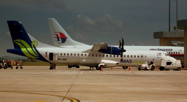 MASwings aircraft beside another bigger aircraft in Miri Airport