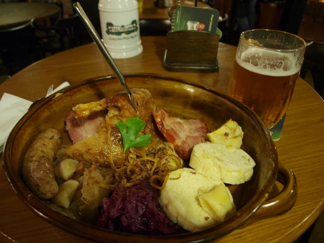 A "traditional Bohemian platter" at restaurant Kolkovna in central Prague, consisting of roast duck, roast pork, beer sausage, smoked meat, red and white cabbage, bread, bacon and potato dumplings.