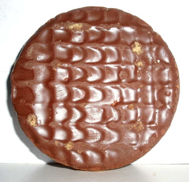 McVitie's chocolate digestive. First produced in 1925, travel writer Bill Bryson called it a “British masterpiece”. It is the most popular biscuit in the UK to dunk into tea.