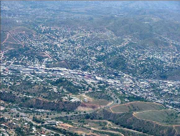 Aerial photograph of the United States-Mexican border, running diagonally from left to right, between Nogales, Arizona, United States, and Nogales, Sonora, Mexico (upper right)