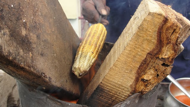 Maize being toasted over an open flame in India.