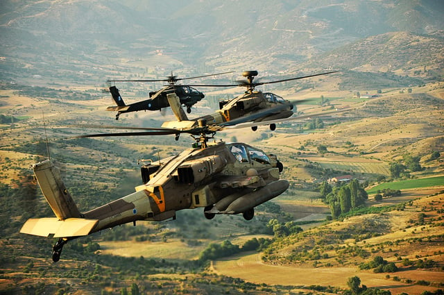 Two IAF Apache AH-64D Longbows and one Greek AH-64A fly above the Greek countryside during a joint exercise, June 2011