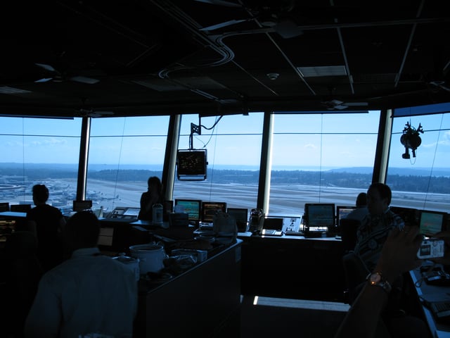 The interior of Sea–Tac's control tower, commissioned in 2004, is 850ft2 (79m2). At center is a radar display; at top right is the light gun