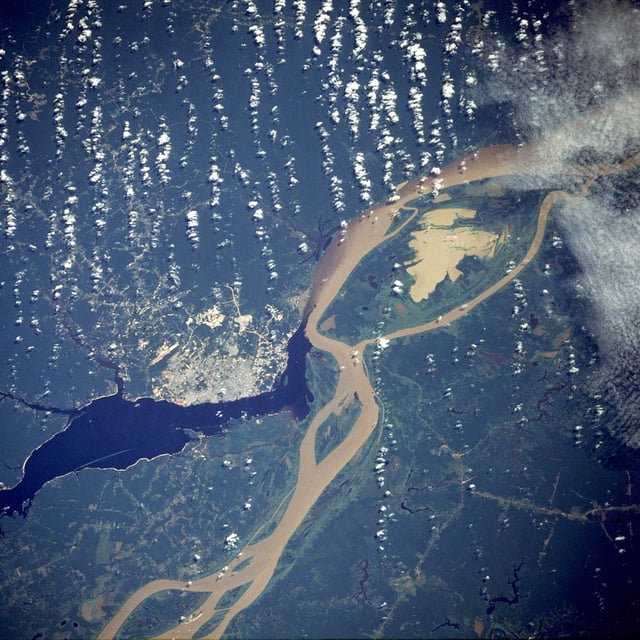 Manaus, the largest city in Amazonas, as seen from a NASA satellite image, surrounded by the dark Rio Negro and the muddy Amazon River