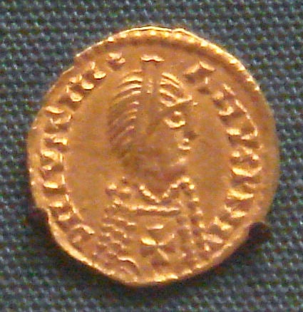 Spanish Visigothic gold tremisses in the name of emperor Justinian I, 7th century. The Christian cross on the breast defines the Visigothic attribution. British Museum.