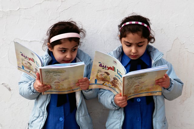 Jordanian school girls pictured reading in a public school.