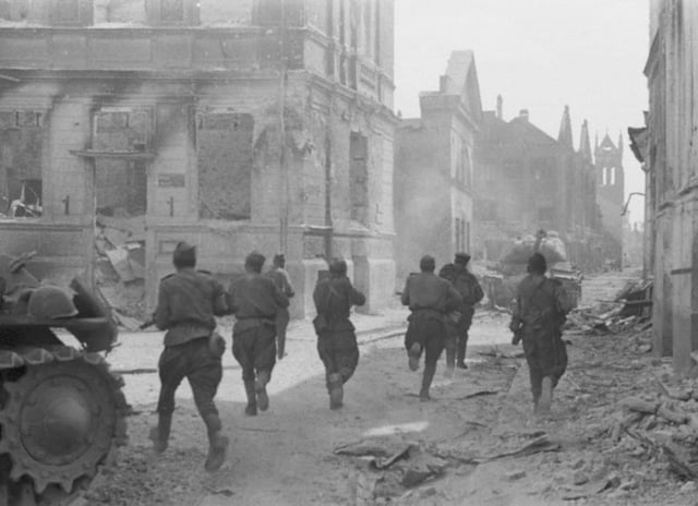 Soviet soldiers advance through the streets of Jelgava; summer 1944