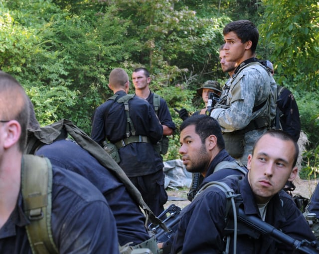 A Special Forces candidate conducts a pre-mission rehearsal with Army ROTC cadets role-playing guerrilla fighters during ROBIN SAGE.