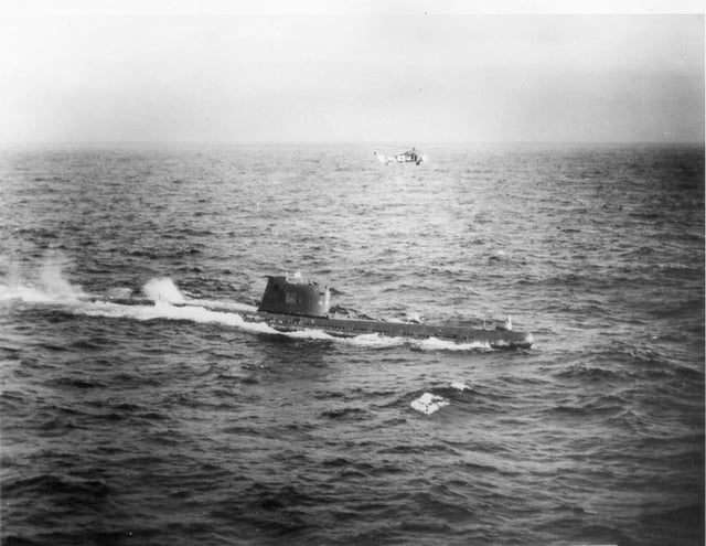 A US Navy HSS-1 Seabat helicopter hovers over Soviet submarine B-59, forced to the surface by US Naval forces in the Caribbean near Cuba (October 28–29, 1962)