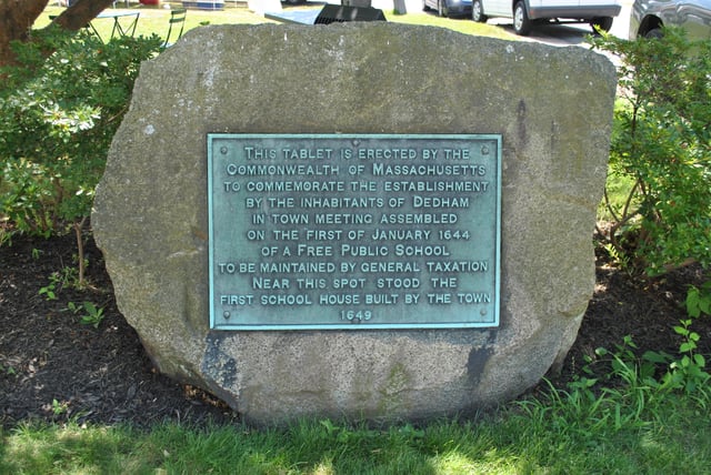 Stone plaque marking the site of the first public school in America in Dedham, Massachusetts