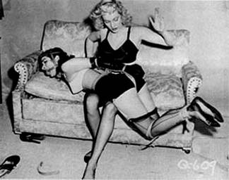 Bettie Page is tied and spanked in an image from Bizarre.