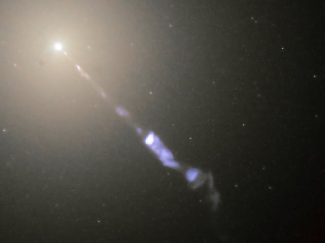 Figure 5-5. Galaxy M87 streams out a black-hole-powered jet of electrons and other sub-atomic particles traveling at nearly the speed of light.