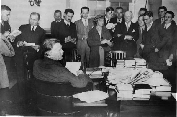 Borah (seated) holds a press conference, 1935