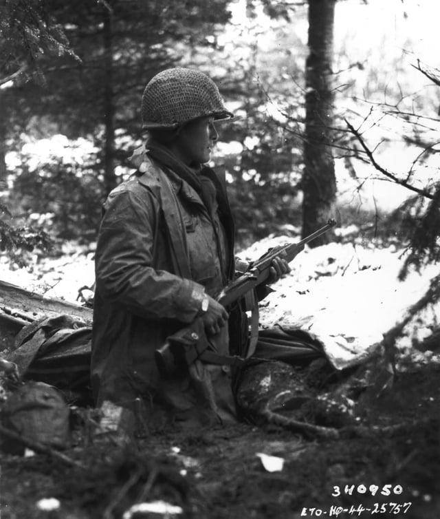 A 442nd RCT squad leader, Sergeant Inouye, checks for German units in France in November 1944.