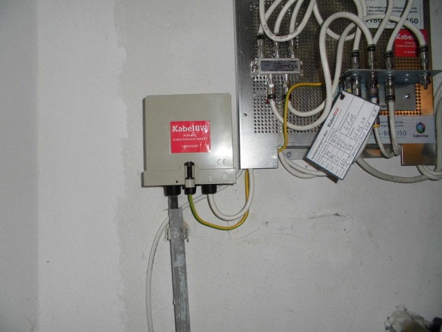 A cable television distribution box (left) in the basement of a building in Germany, with a splitter (right) which supplies the signal to separate cables which go to different rooms