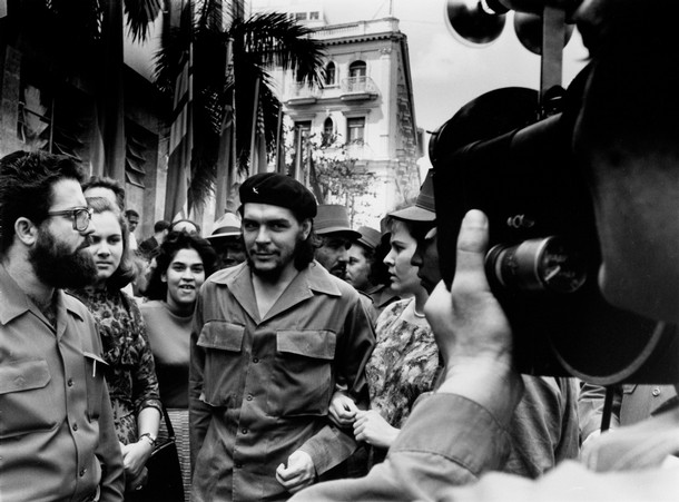 Guevara in 1960, walking through the streets of Havana with his wife Aleida March (right)