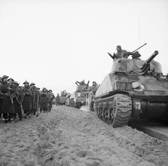 Sherman tanks of the 46th Royal Tank Regiment come ashore with infantry of the 1st Battalion, Loyal Regiment (North Lancashire) at Anzio, Italy, 22 January 1944.