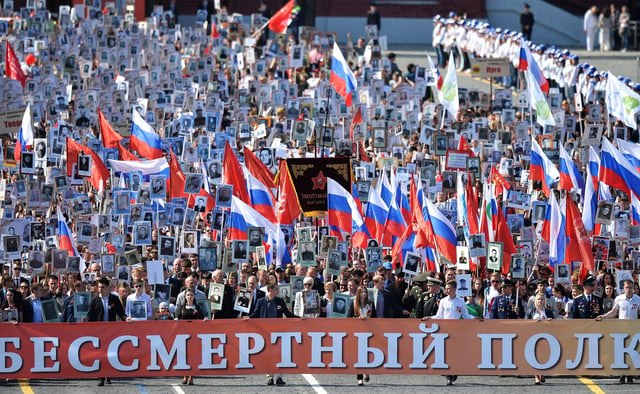 Members of the Immortal regiment carrying portraits of their ancestors who fought in World War II at the 2015 Moscow Victory Day Parade