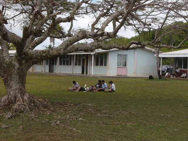 Students using their OLPC laptops in the school yard.