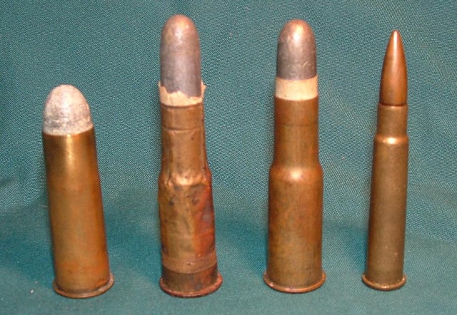 (From Left to Right): A .577 Snider cartridge (1867), a .577/450 Martini-Henry cartridge (1871), a later drawn brass .577/450 Martini-Henry cartridge, and a .303 British Mk VII SAA Ball cartridge.