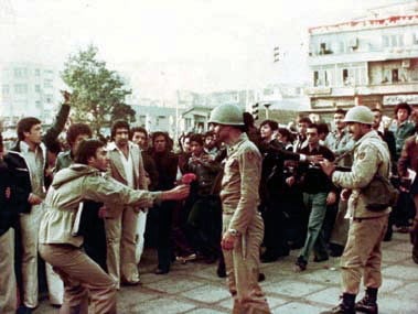 A protester giving flowers to an army officer